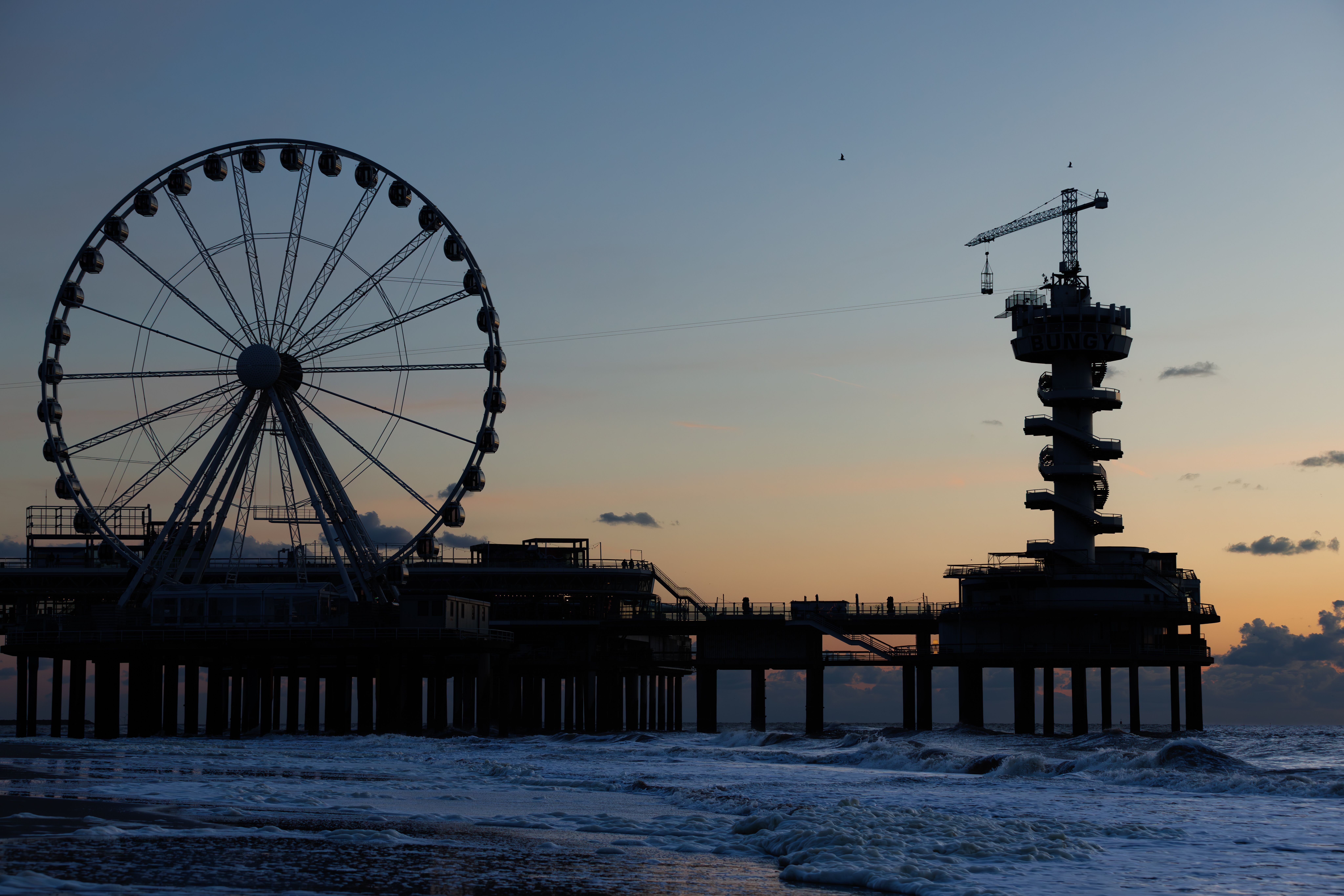 A ferris wheel and pier at sunset · Free Stock Photo