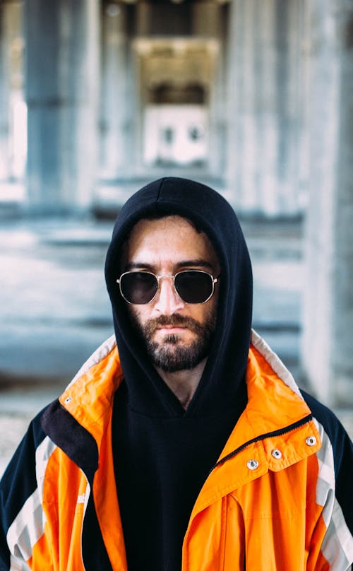 A man in an orange jacket and sunglasses