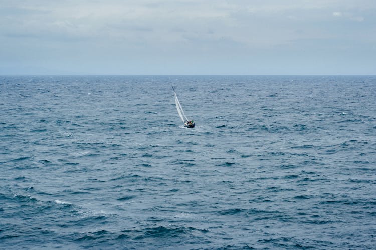 Boat Sailing On Body Of Water