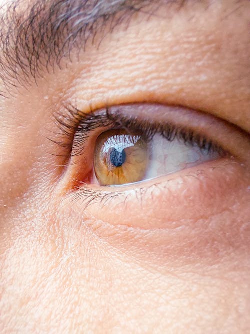 A close up of a man's eye with a blue background