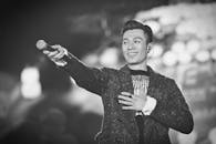 舞台上歌手热情表演的单色照片