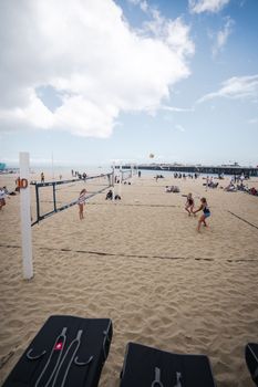 Dynamic beach volleyball match with a group playing under clear skies in Santa Cruz.