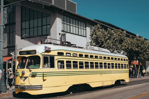 Yellow Bus on the Road Near Buildings