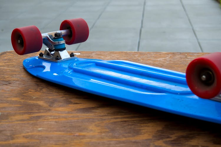 Blue Penny Board On Wooden Table