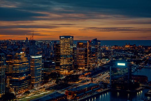 Panoramic night view of Buenos Aires skyline with illuminated skyscrapers and waterfront.