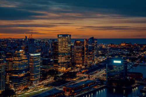 Free Panoramic night view of Buenos Aires skyline with illuminated skyscrapers and waterfront. Stock Photo