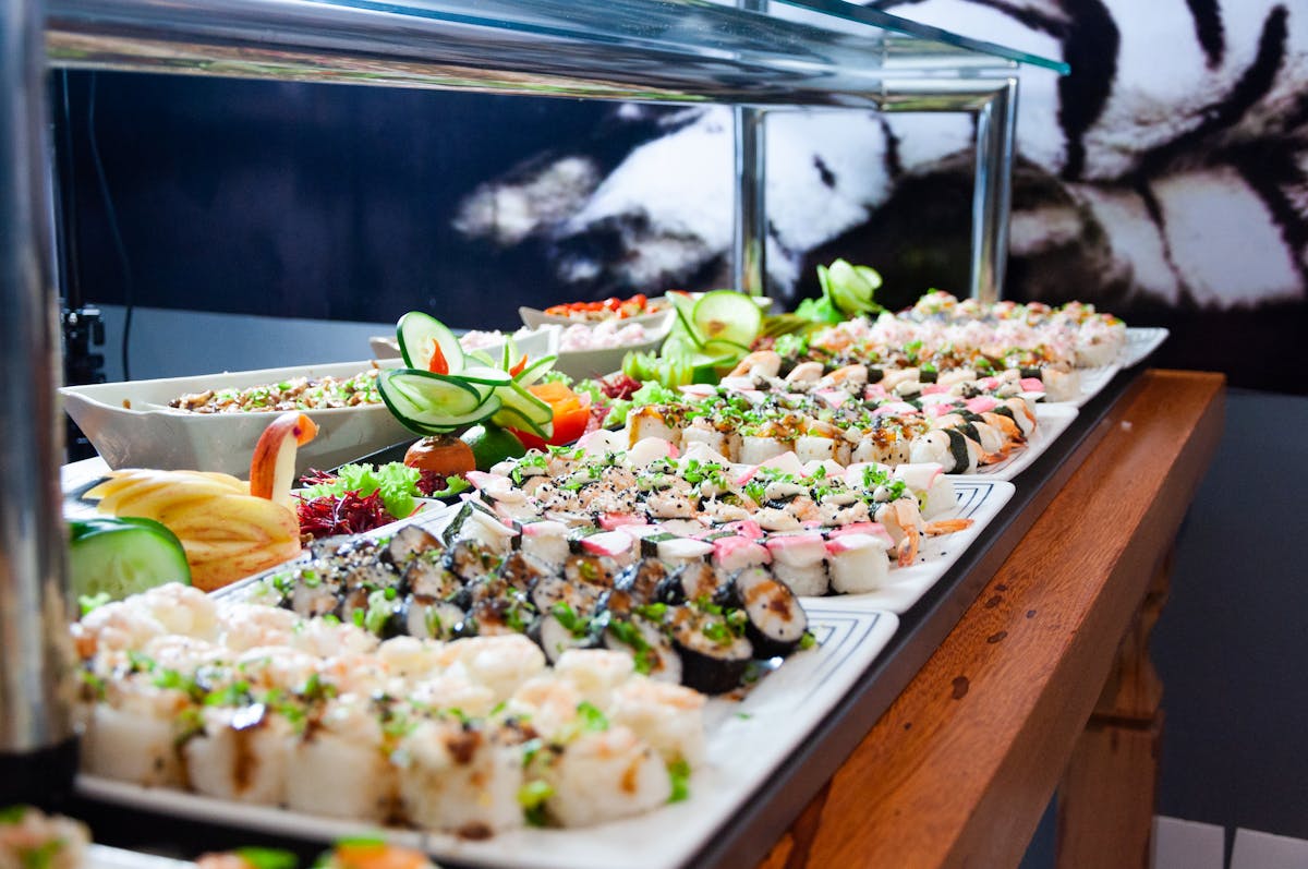 Sushi on White Plates on Brown Wooden Table