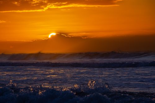 Free Vivid sunset over the ocean waves in Necochea, Argentina, capturing the serene beauty of nature. Stock Photo