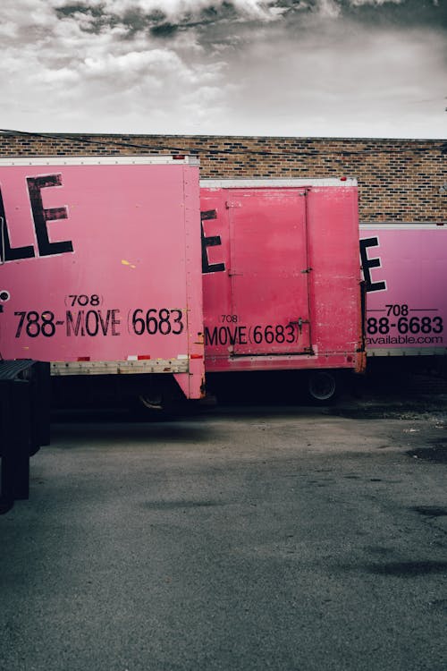 Three Assorted-color Box Trucks