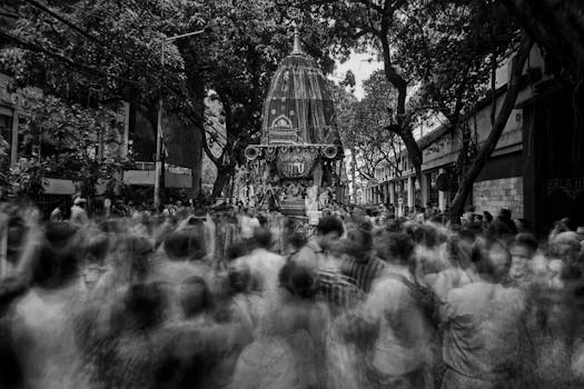 A dynamic street scene depicting a moving crowd during a festival procession in Kolkata.