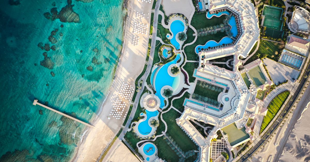 Stunning aerial view of a luxury resort in Hurghada, featuring pools and beach by the Red Sea.