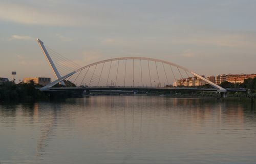 Free Stunning evening view of La Barqueta Bridge over river in Seville, Spain. Stock Photo
