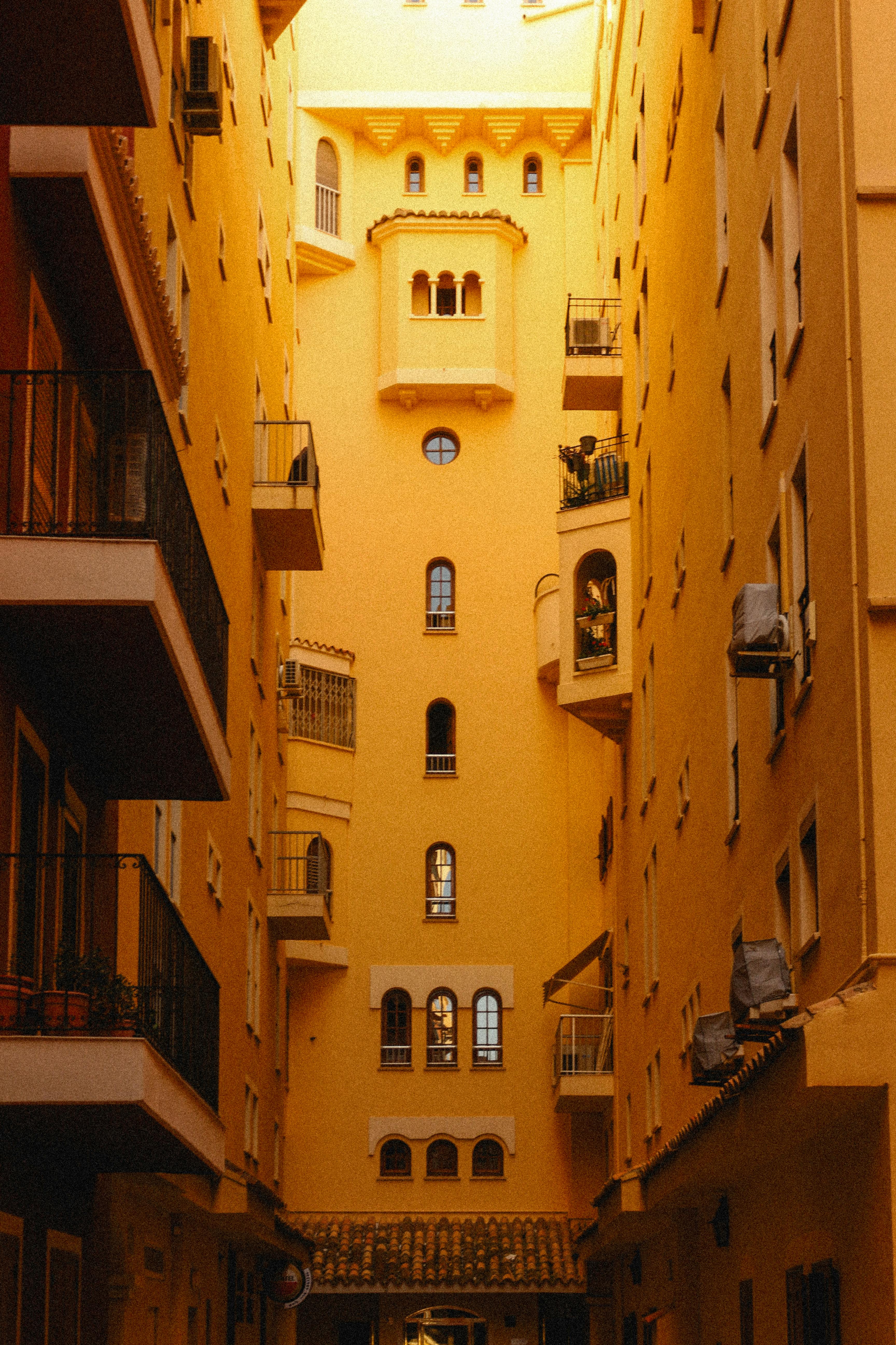 Warm, yellow-toned urban scene captures Valencia's unique architecture.