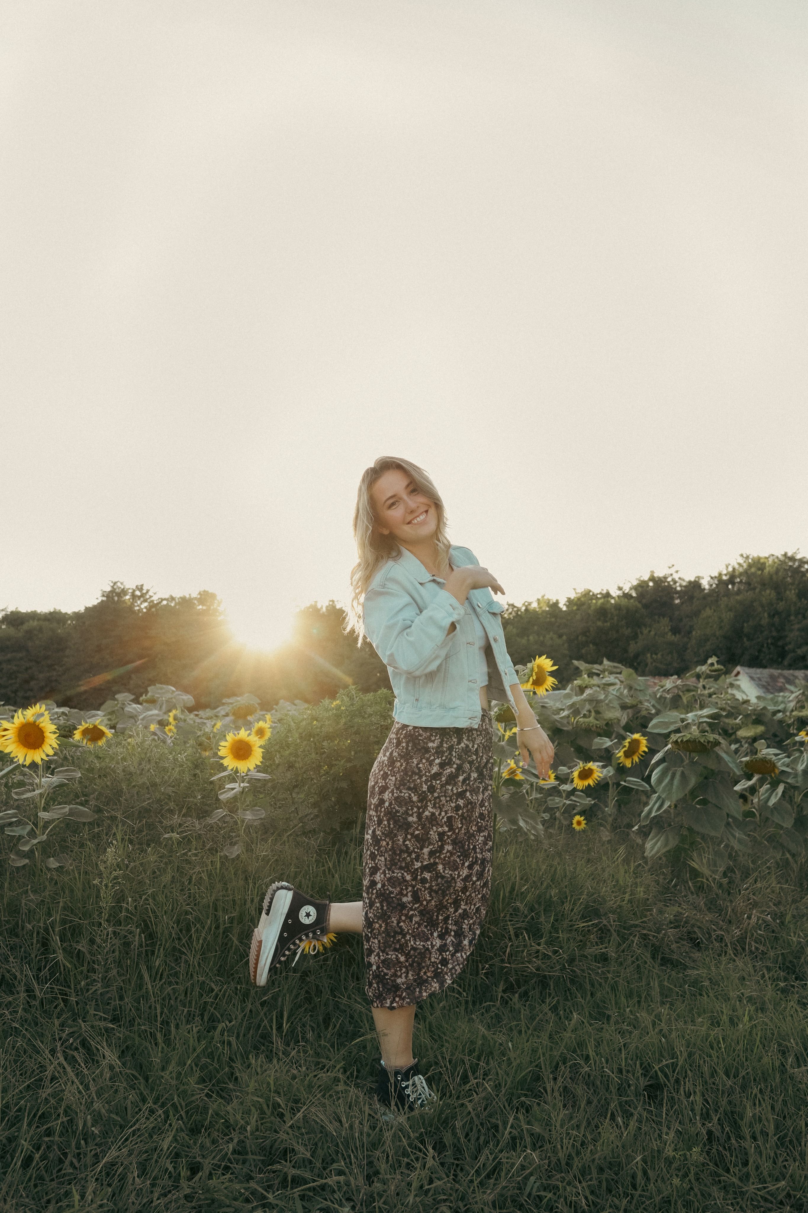 A woman standing in a field of sunflowers · Free Stock Photo