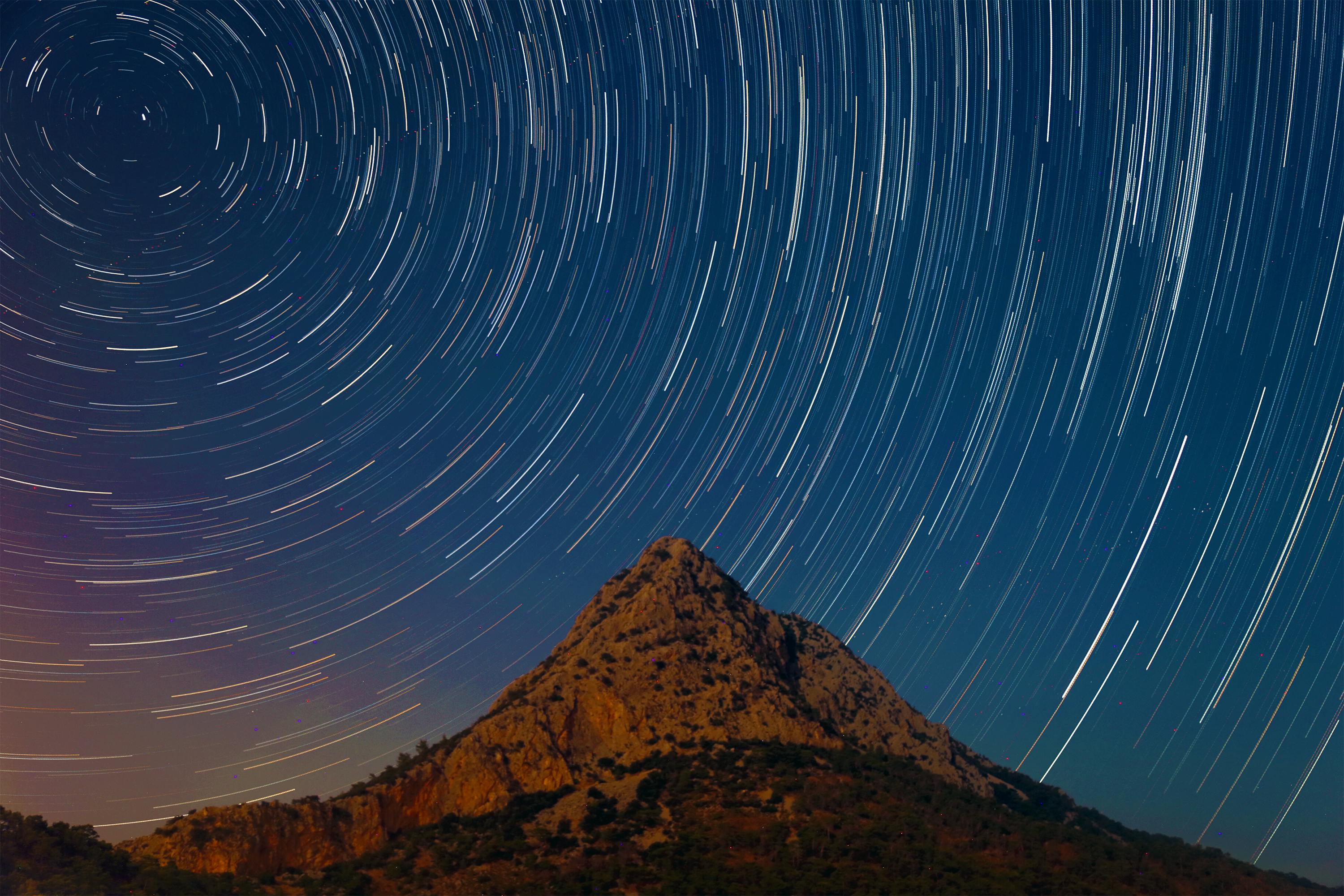 mountain under a starry sky in timelapse mode