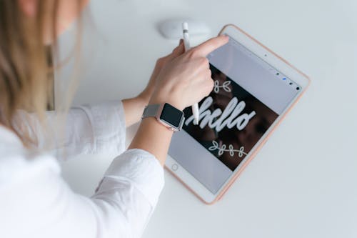 Free Woman With Applewatch Holding Gold Ipad and Apple Pencil Stock Photo