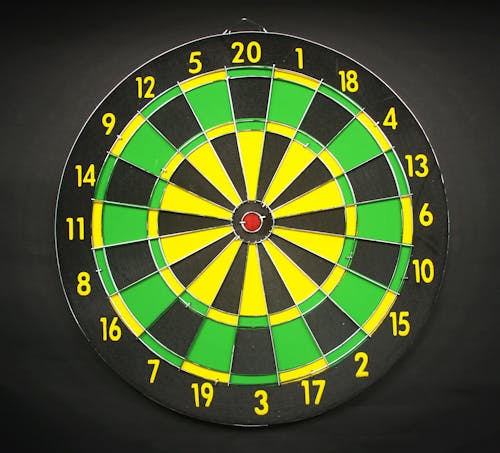 Free Green Yellow and Black Round Dart Board With Black Background Stock Photo