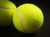 Shallow Focus Photo of Two Tennis Balls
