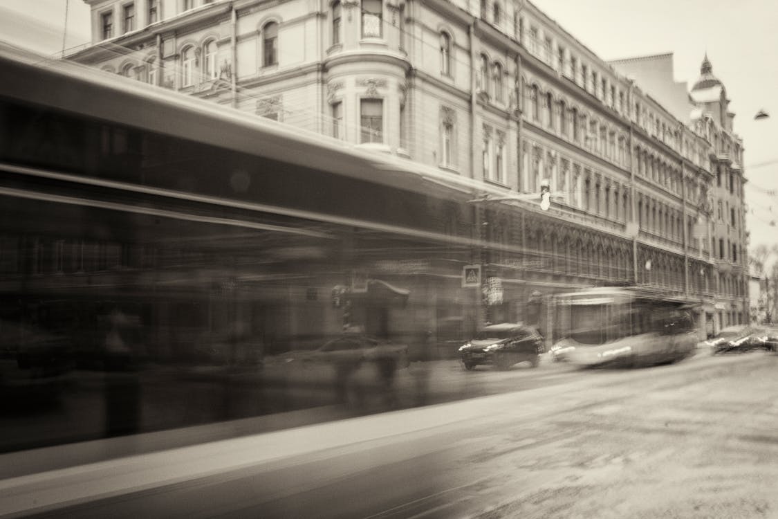 Free Grayscale View of City With Vehicles Passing Through Stock Photo