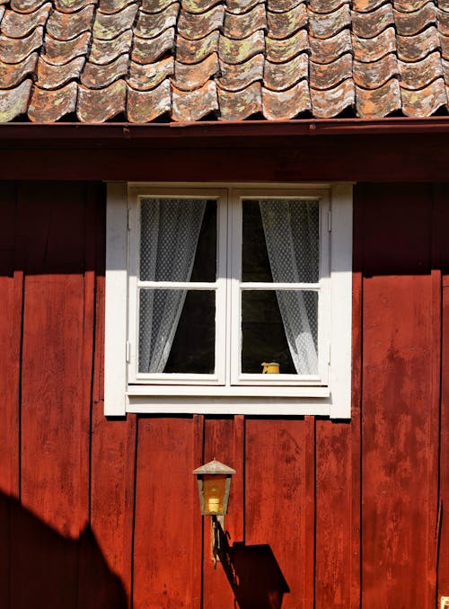 A window with a tiled roof and a tiled window sill