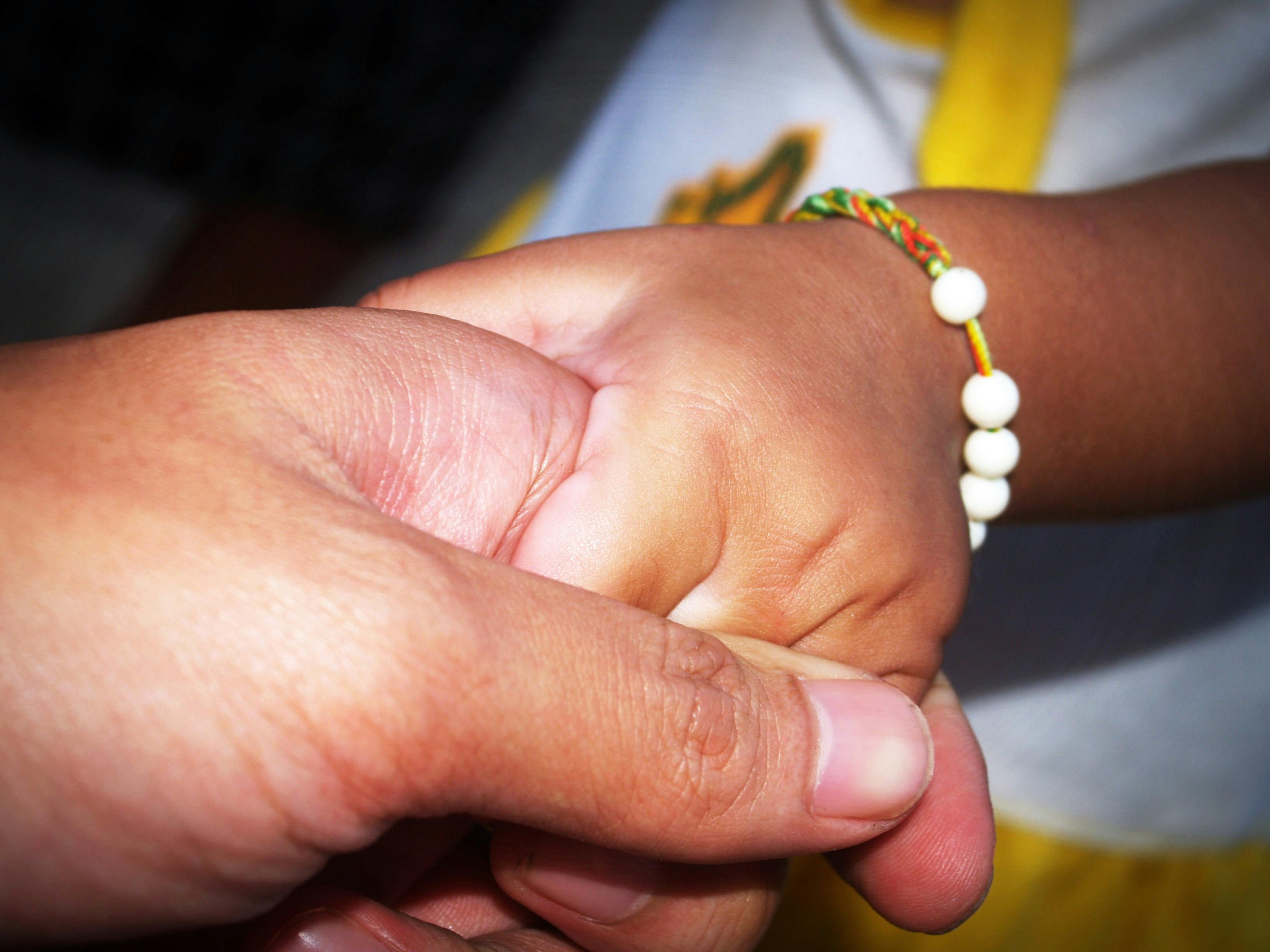 person holding child s hand