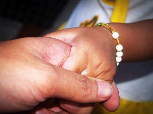 Free Person Holding Child's Hand Stock Photo