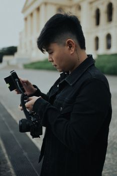 A young man explores the streets of São Paulo, capturing images with his camera.