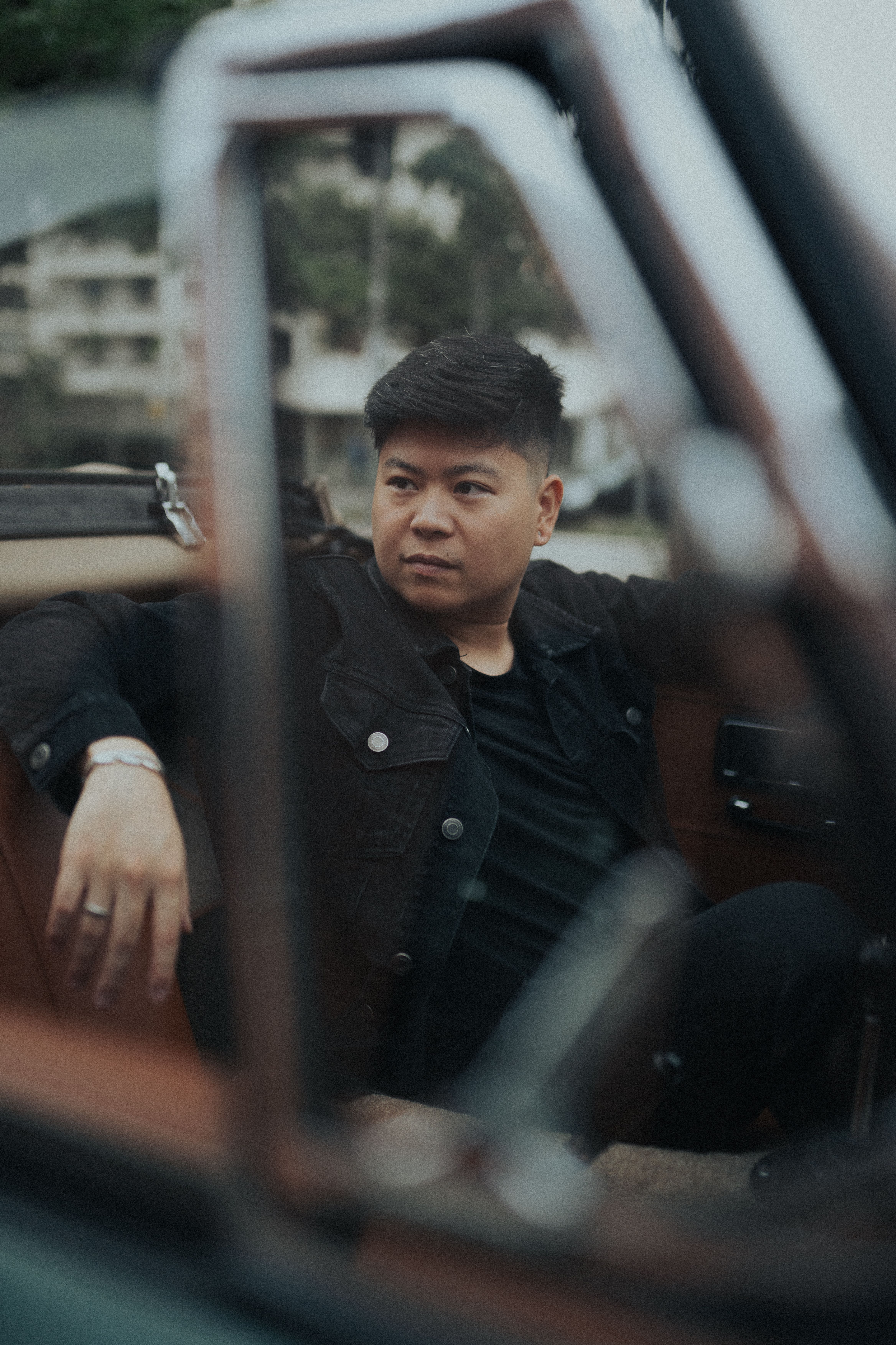 Portrait of a man sitting in a vintage convertible car in São Paulo.