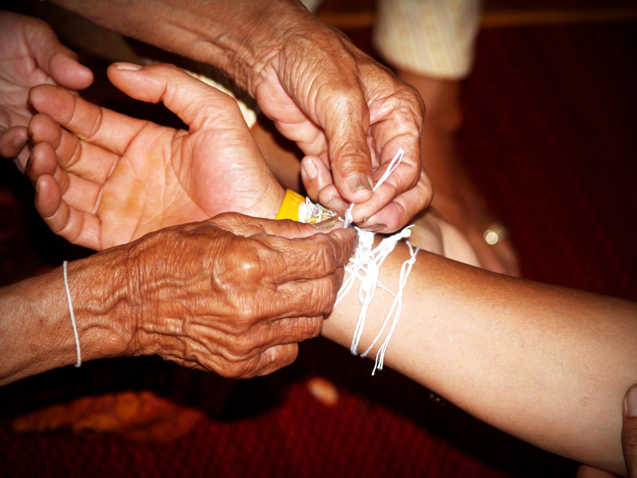 Person Tying Rope to Person Right Hand