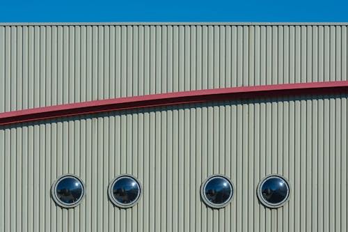 A building with three round windows and a blue sky