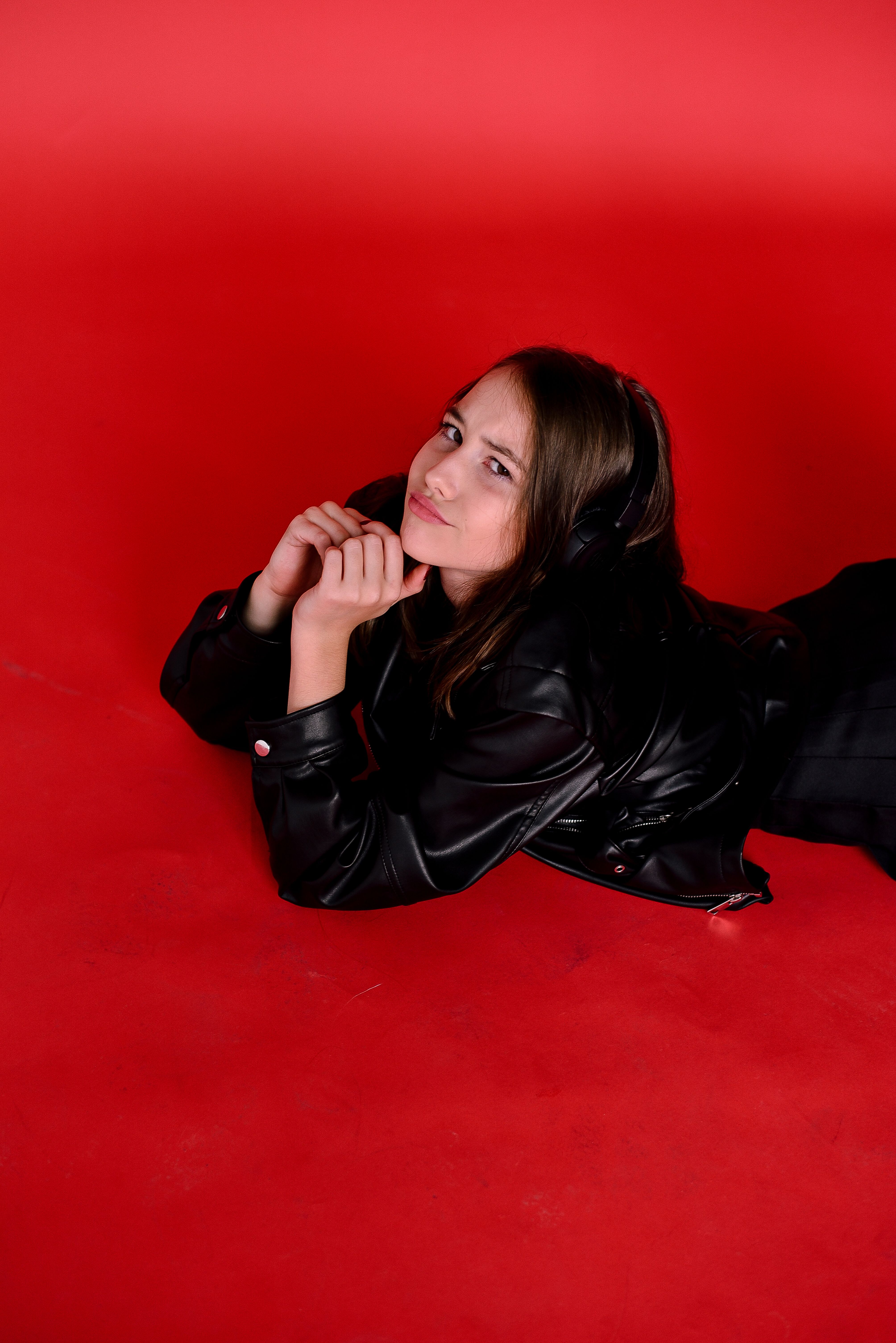 Woman in a Black Leather Jacket Lying on the Floor · Free Stock Photo