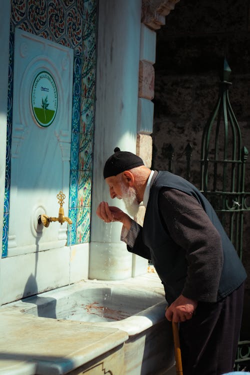 Man Cleaning Hands in a Mosque 