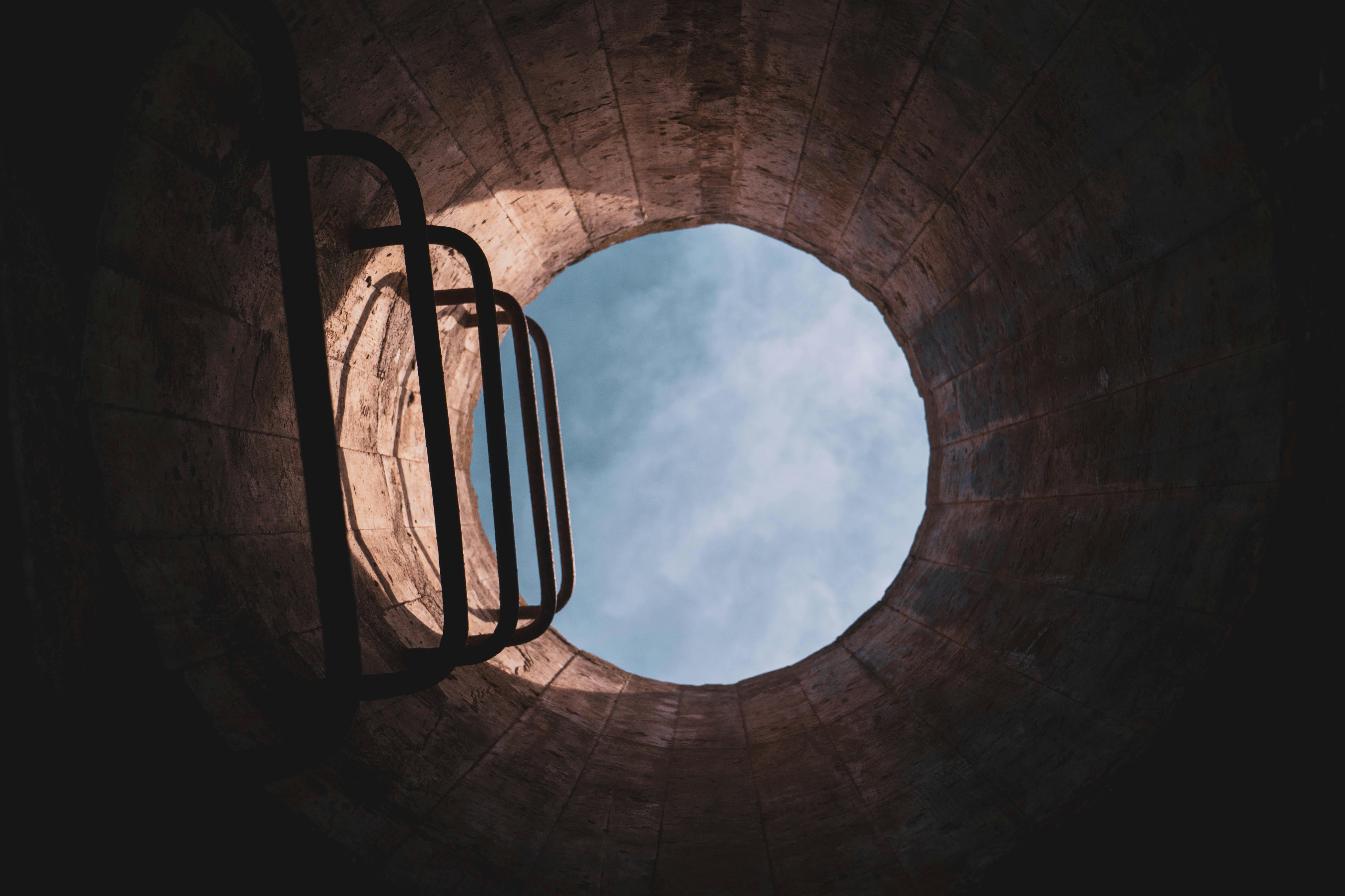 A view of a hole in the ground with a ladder