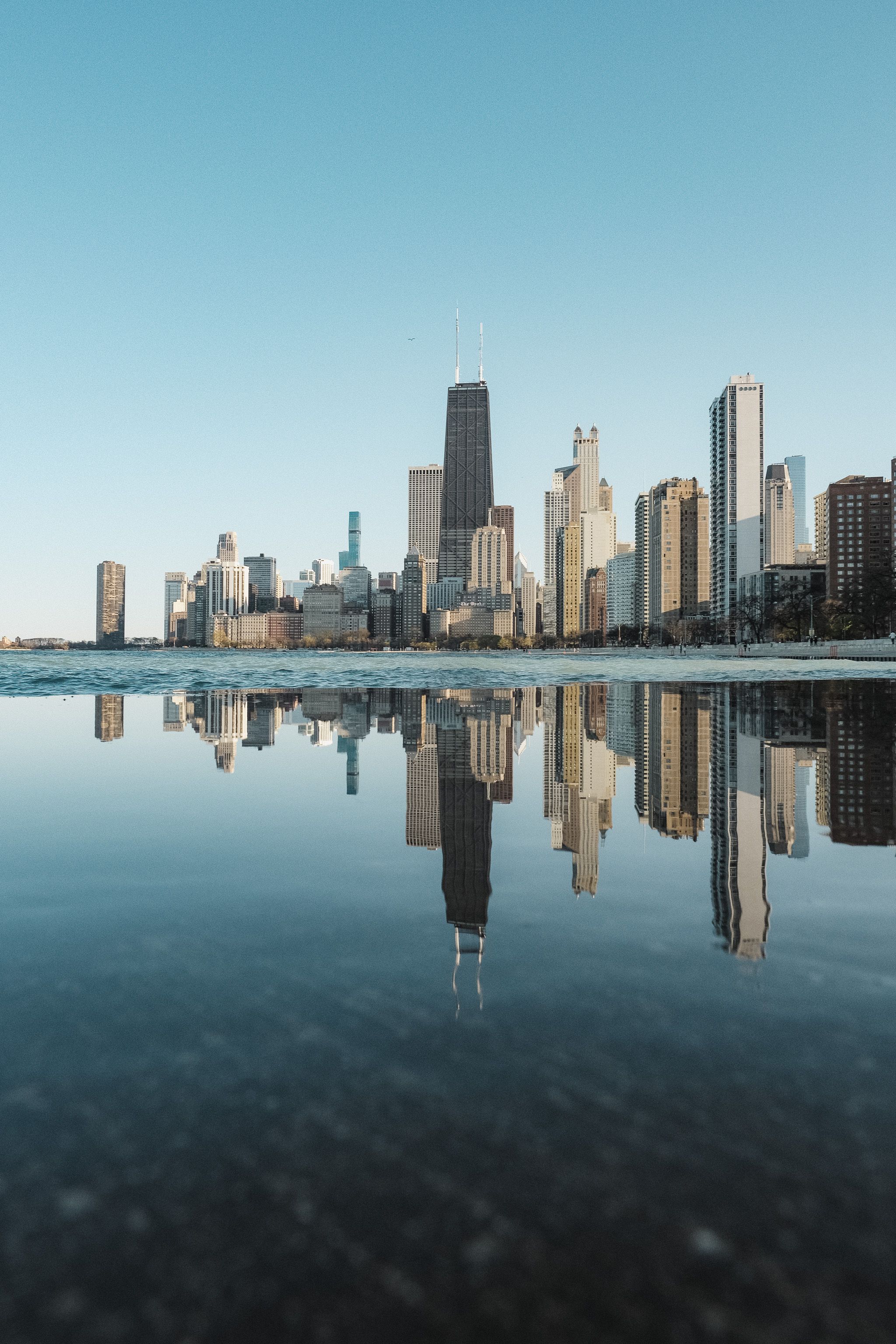 Skyscrapers reflected in the Chicago River near The Langham hotel on Wabash Avenue