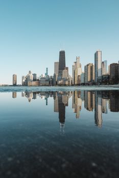 Captivating reflection of Chicago skyline in river, showcasing skyscrapers and urban beauty.