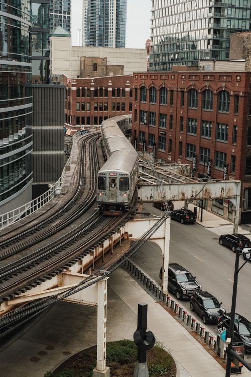 Free Elevated train winding through Chicago's urban architecture against a backdrop of skyscrapers. Stock Photo