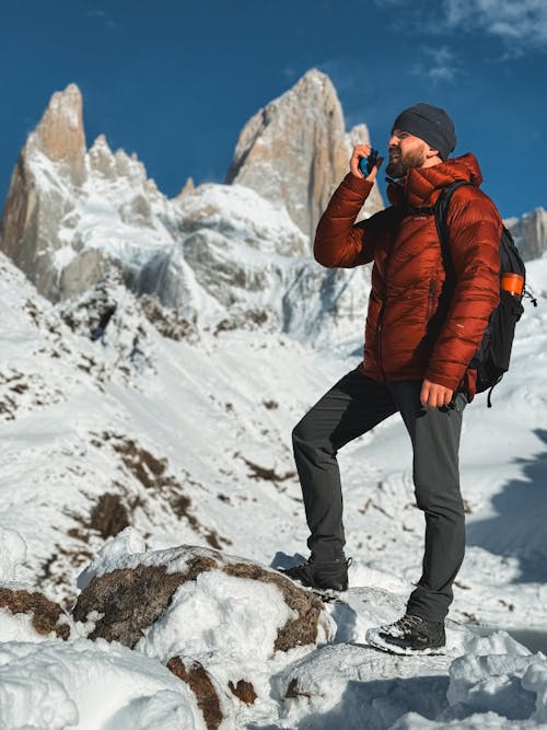 A Man Standing near the Fitz Roy Mountain in Patagonia between Argentina and Chile 