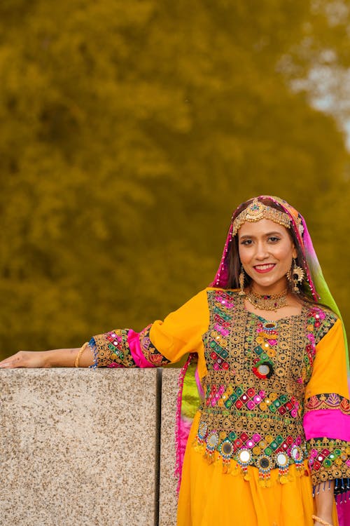 A woman in a colorful dress posing for a photo