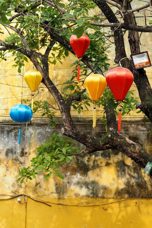 A typical scene in the ancient town of Hoi An (Vietnam) with yellow walls and colorful lanterns