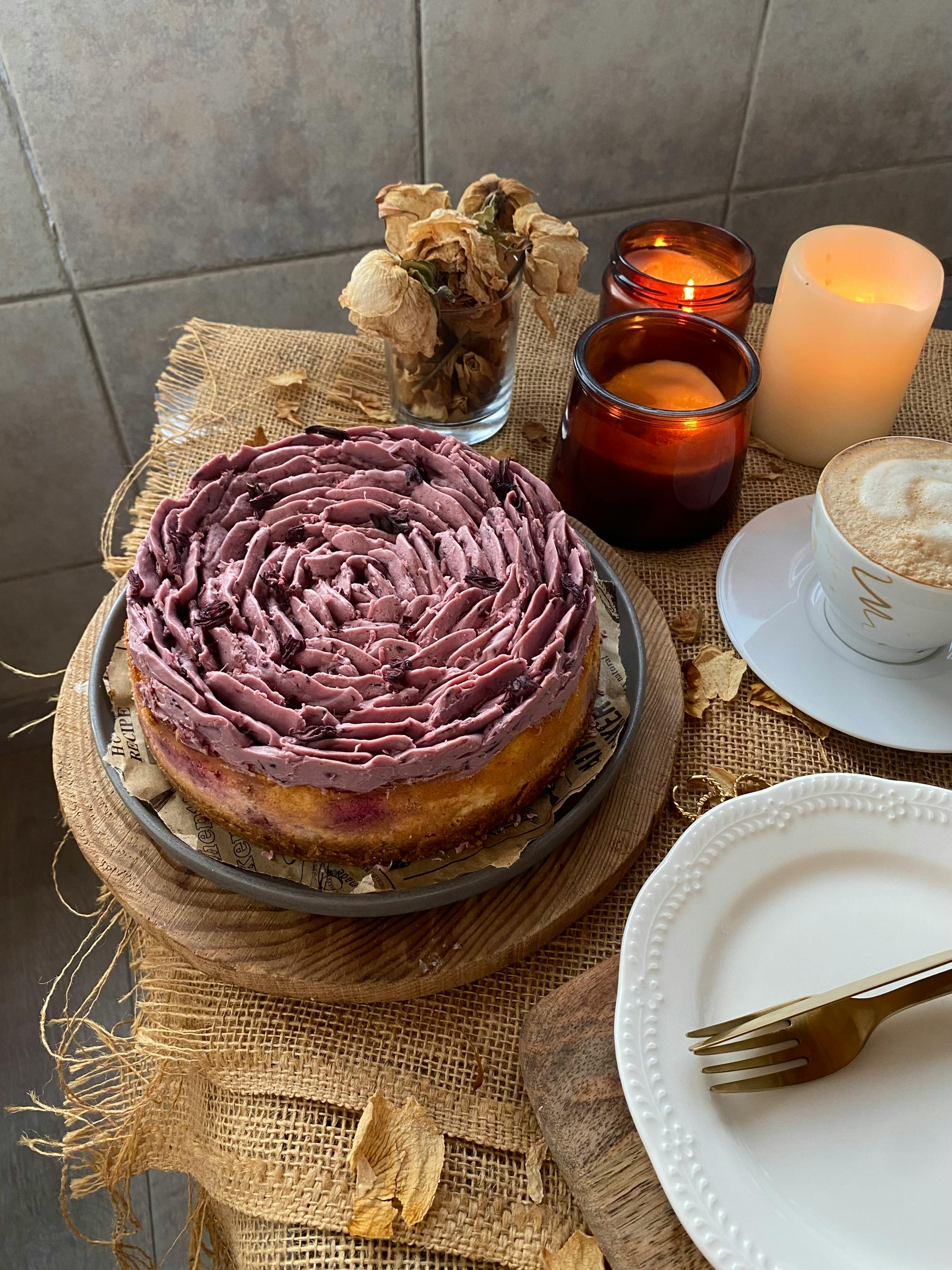 A beautifully frosted cake surrounded by candles, a perfect still life composition.
