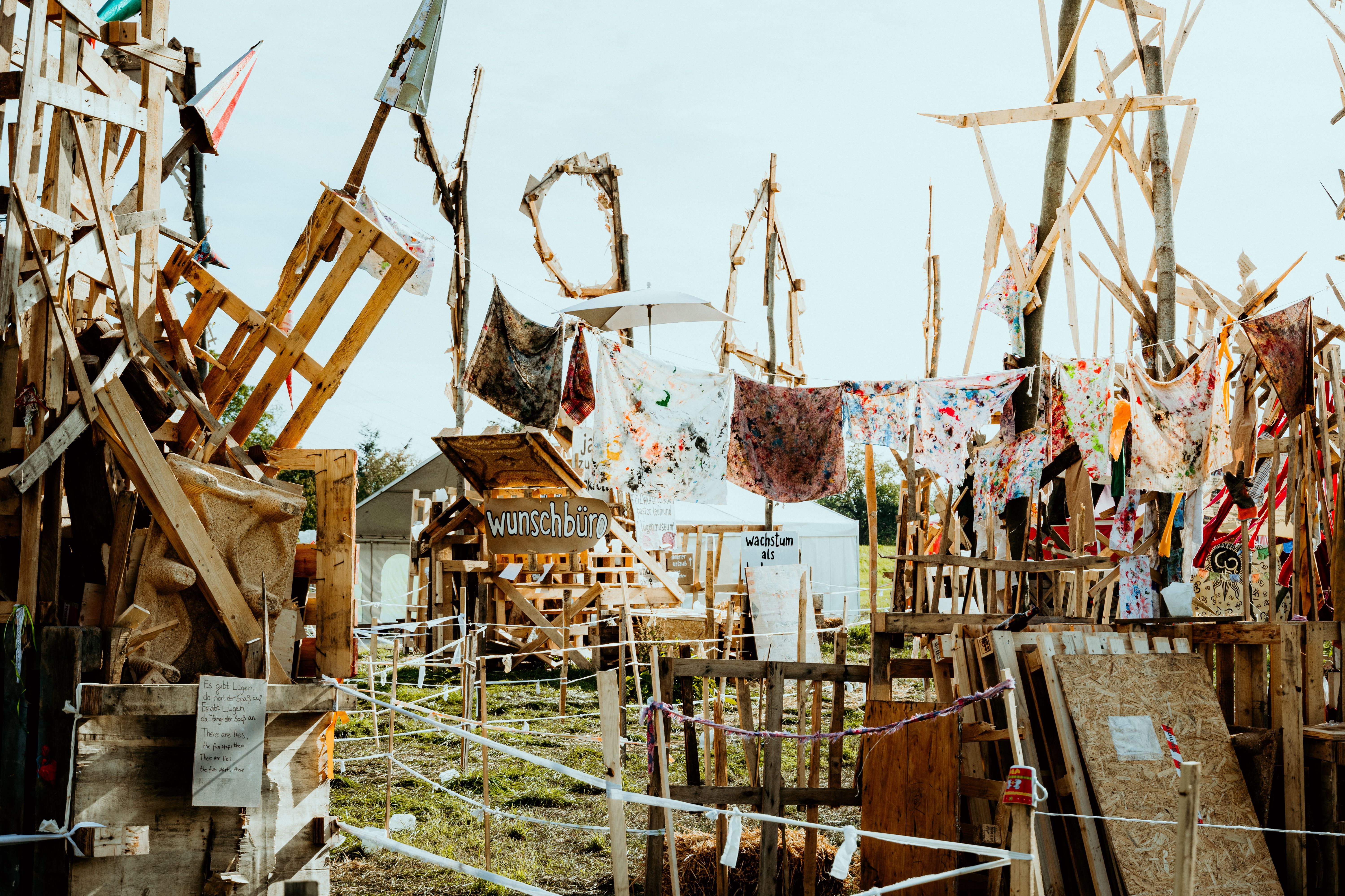 Clothes, Railings and Planks in Messy Field · Free Stock Photo