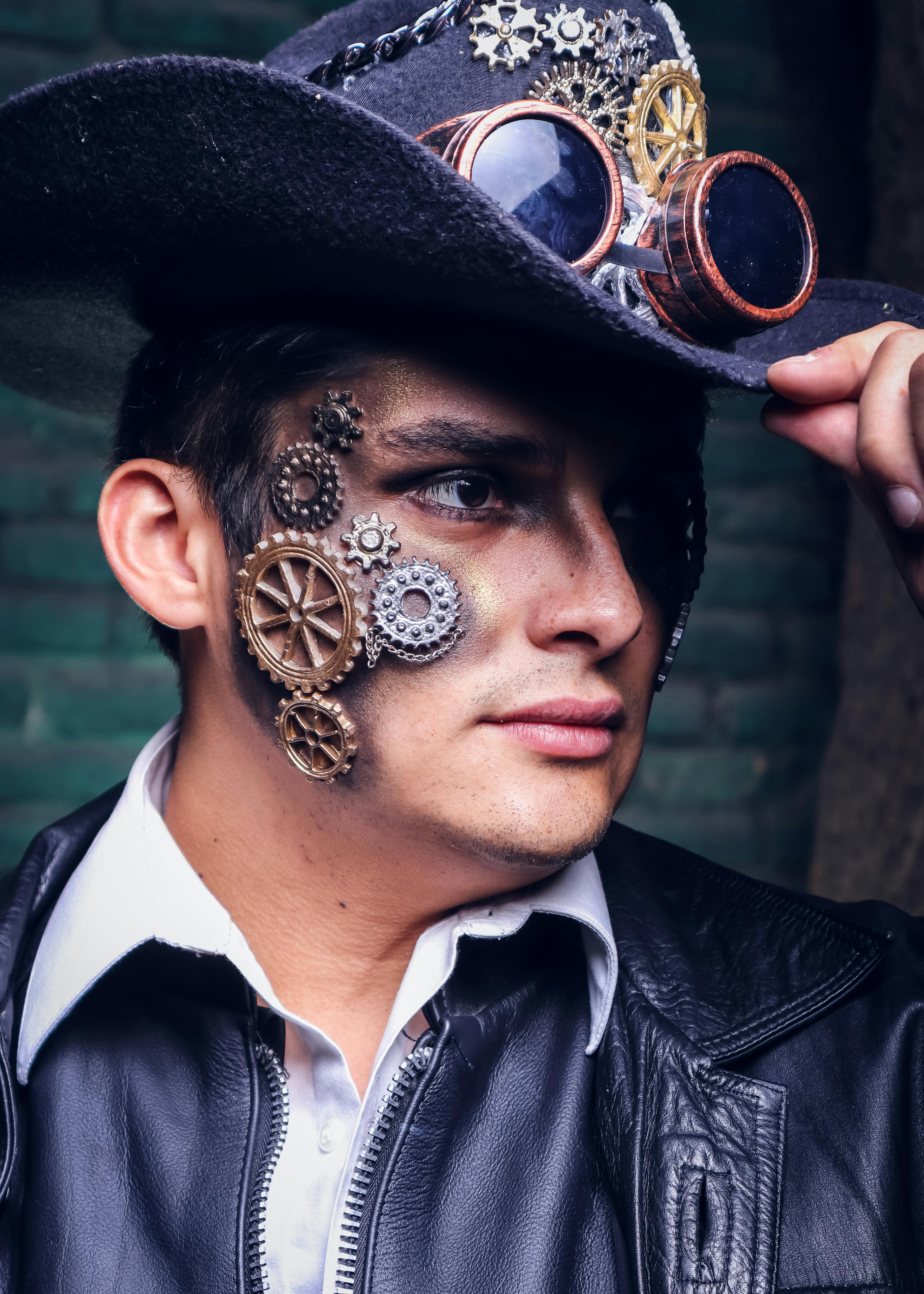 Portrait of a man in steampunk attire with gears and goggles in a stylish pose.