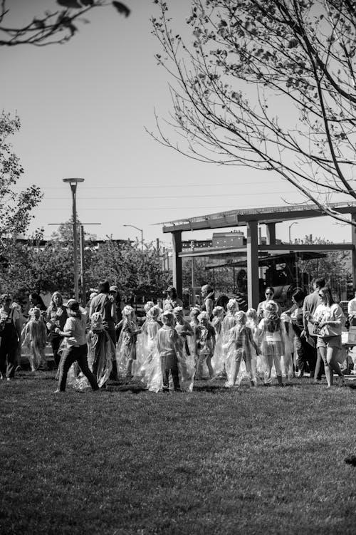 Black and white photo of people walking in a park