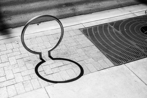 Free Artistic black and white photo of a sidewalk with metal ring shadow in Boise, Idaho. Stock Photo