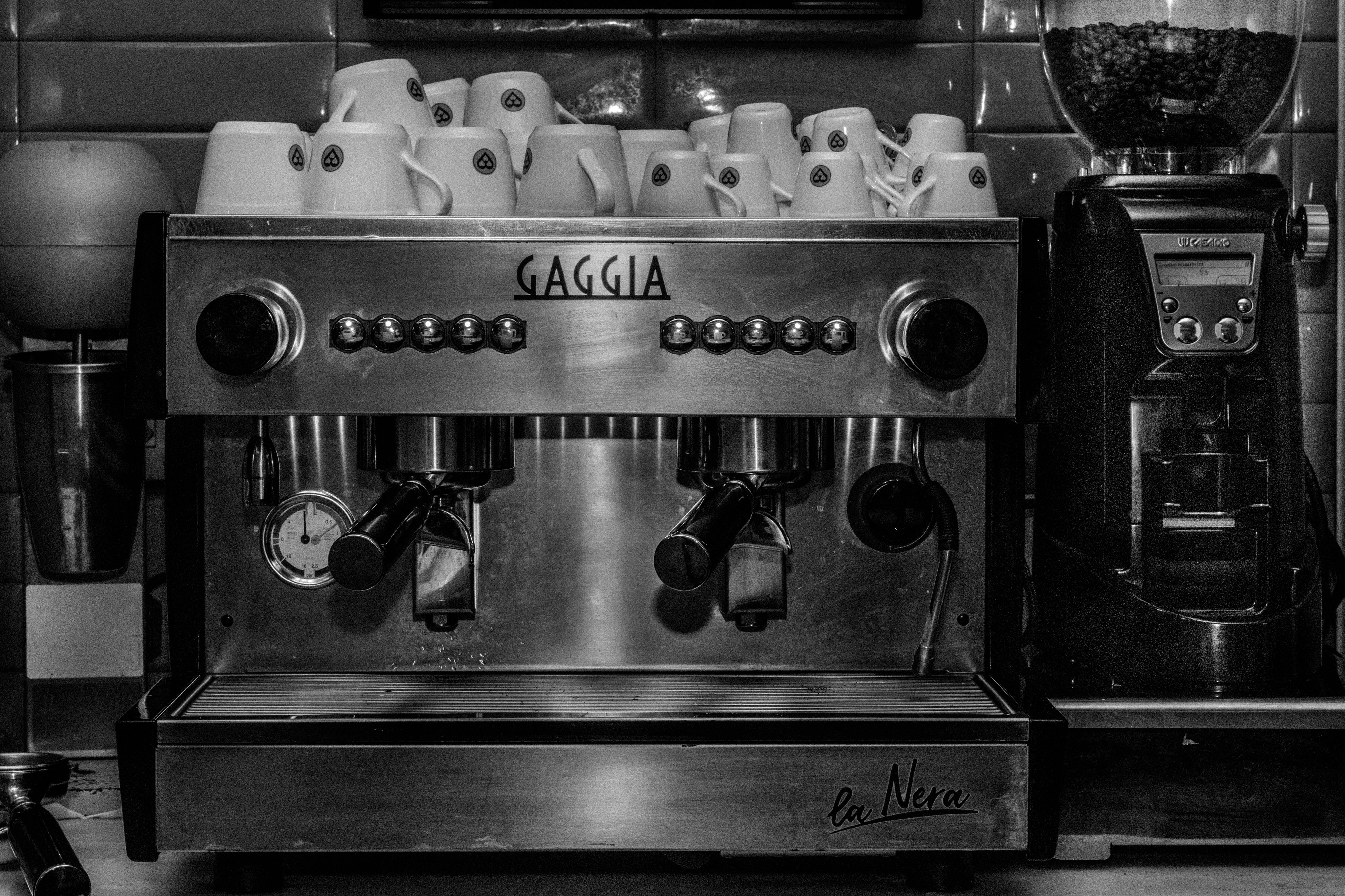 Fresh coffee beans and ground coffee next to single-cup coffee maker