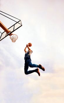An exciting shot of a basketball player dunking during a game, capturing the action mid-air.