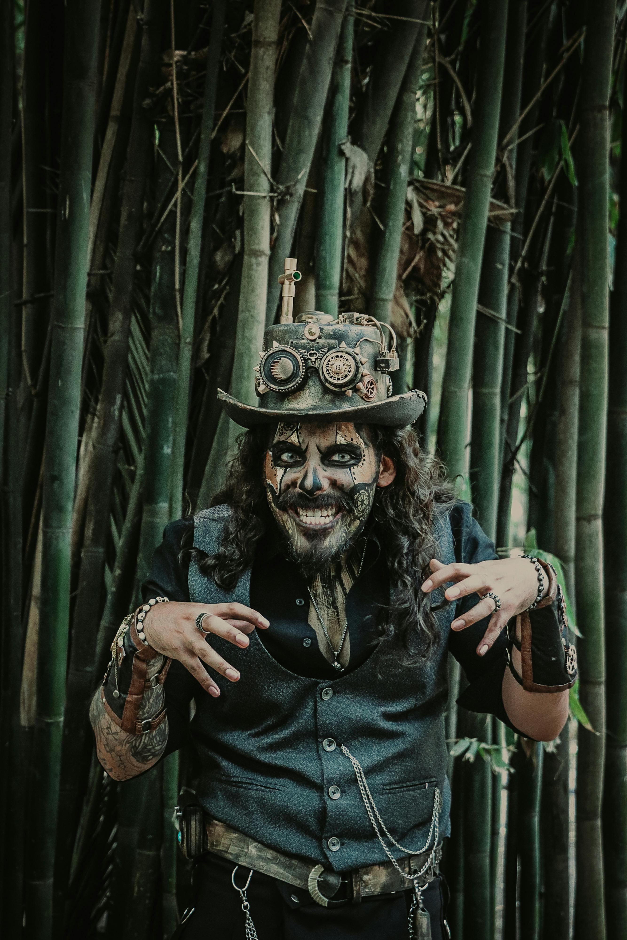 A man in steampunk attire poses playfully in a bamboo forest in Mexico City.
