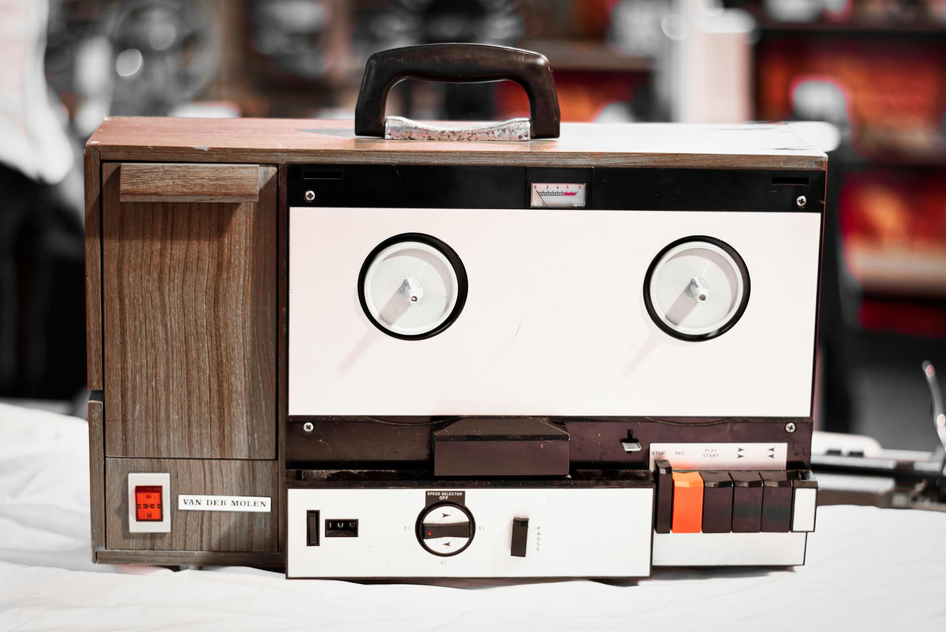 Close-up of a classic vintage reel-to-reel tape recorder with wooden paneling and dials.