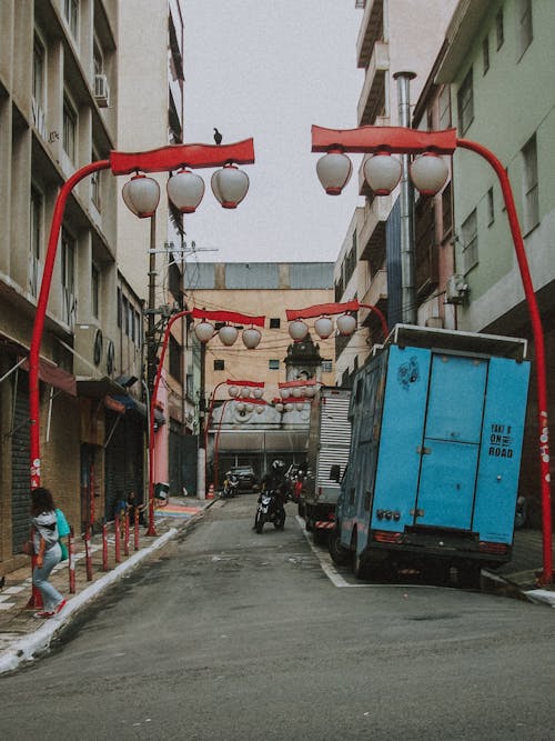 A street with red lanterns hanging from the street