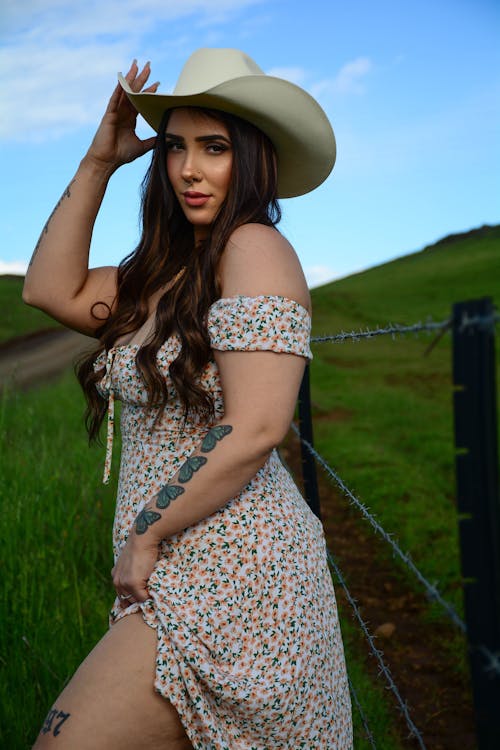 A woman in a cowboy hat posing for a photo